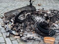 The Hague, Netherlands - January 1, 2023: Burned Garbage and a wheel cart in The Hague after the new year celebrations