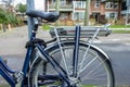 Electric bike and battery parked on street and locked against pole