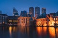 The Hague\'s Binnenhof with the Hofvijver lake and modern buildings at dusk, Den Haag, Netherlands