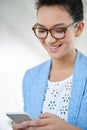 Haha, awesome. an attractive young woman using a cellphone in an office. Royalty Free Stock Photo