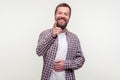 Haha, hey you! Portrait of joyful bearded man pointing finger and holding belly, can`t stop laughing. white background