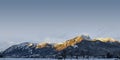 Hahnenkamm mountain range in reutte with morning sun-illuminated, snow-capped peaks