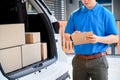 Thai mailman checking parcel and mail boxes for home delivery. Royalty Free Stock Photo