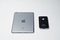 Hai, Ukraine - August 10, 2017: iPad tablet and iPhone 4 smartphone produced by Apple laying on the white surface. Royalty Free Stock Photo