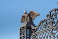 Decorative statue of a metal eagle with outstretched wings on the decorative metal entrance gate on the upper terrace of the Bahai