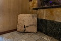 A large stone with a cross carved on it as an exhibit in the museum of the Stella Maris Monastery which is located on Mount Carmel