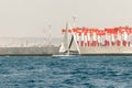 A private yacht sails in the waters of the Haifa Bay, against the background of Haifa port, in the Mediterranean Sea, near the Royalty Free Stock Photo