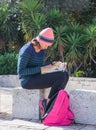 Young girl sitting outdoors and reading a book in Haifa, Israel