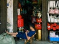 HAIKOU, HAINAN, CHINA - MAR 2 2019 Ã¢â¬â a shopkeeper of Chinese Taoist / Daoist / Buddhist prayer shop in Bo`ai Road, Haikou,