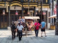 HAINAN, CHINA - 3 MAR 2019 - Asian Chinese family take a horse buggy ride at Feng Xiao Gang Movie Town in Hainan, a popular theme