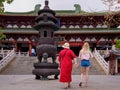 HAINAN, CHINA - 5 MAR 2019 Ã¢â¬â Two White Caucasian female tourists visit Nanshan temple in Hainan, China Royalty Free Stock Photo