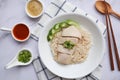 Hainanese Chicken over fragrant rice- Top view on the marble table