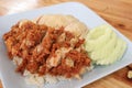 Hainanese chicken rice with Roasted Chicken on wooden table.Hainanese chicken rice is a dish of poached chicken and seasoned rice Royalty Free Stock Photo