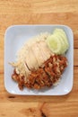 Hainanese chicken rice with Roasted Chicken on wooden table.Hainanese chicken rice is a dish of poached chicken and seasoned rice Royalty Free Stock Photo