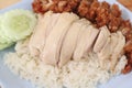 Hainanese chicken rice with Roasted Chicken on wooden table.Hainanese chicken rice is a dish of poached chicken and seasoned rice Royalty Free Stock Photo