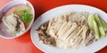 Hainanese chicken rice special set close up photo on red desk served with hot soup, Asian food in Thailand Royalty Free Stock Photo