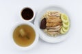 Hainanese chicken rice, steamed chicken, chicken blood and white rice on brown cloth background.