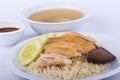 Hainanese chicken rice, steamed chicken, chicken blood and white rice on brown cloth background.