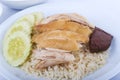 Hainanese chicken rice, steamed chicken, chicken blood and white rice on brown cloth background.