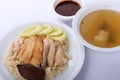 Hainanese chicken rice, steamed chicken, chicken blood and white rice on brown cloth background.