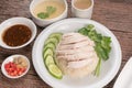 Hainanese chicken rice on a white table background, Steamed chicken rice with spicy sauces and chicken soup, Royalty Free Stock Photo