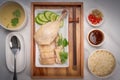 Hainanese chicken rice on a white table background, Steamed chicken rice with spicy sauces and chicken soup, Royalty Free Stock Photo