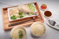 Hainanese chicken rice on a white table background, Steamed chicken rice with spicy sauces and chicken soup, Royalty Free Stock Photo