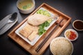 Hainanese chicken rice on a white table background, Steamed chicken rice with spicy sauces and chicken soup, Royalty Free Stock Photo