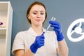 Hair beauty, mesotherapy: a beautician trichologist doctor preparing medication for a needle mesotherapy treatment on a Royalty Free Stock Photo