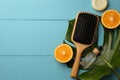 Hair brush, bottle of essential oil, dry shampoo and orange slices on light blue wooden table, flat lay Royalty Free Stock Photo