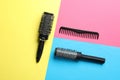 Hair brushes and comb on color background Royalty Free Stock Photo