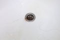 Hair bunch in bath drain. Hair loss after shower and washing head skin and hair. Long hair pile falling down in bathroom Royalty Free Stock Photo