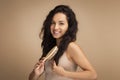 Smiling Beautiful Millennial Indian Woman Brushing Hair Royalty Free Stock Photo