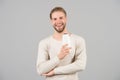 Hair care and beauty supplies concept. Man happy face holds shampoo bottle, grey background. Guy with bristle holds