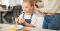 Hair care, brush and kid with mother talking, play and relax in home kitchen during morning breakfast. Mom prepare for Royalty Free Stock Photo