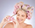 Hair care, curlers and young woman in a studio doing a natural, beautiful and curly hairstyle. Self care, happy and Royalty Free Stock Photo