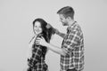 Hair care at home. Helping with hairstyle. Couple having fun with big comb. Combing and brushing hair. Man and woman