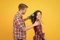 Hair care at home. Helping with hairstyle. Couple having fun with big comb. Combing and brushing hair. Man and woman