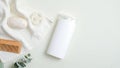 Hair care product design concept. SPA cosmetic bottle packaging, wooden hair comb, white towel, organic soap, luffa sponge on
