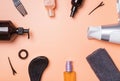 Hair care produts and styling items on orange background Royalty Free Stock Photo