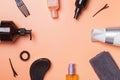 Hair care produts and styling items on orange background Royalty Free Stock Photo