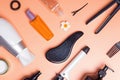 Hair care produts and styling items on orange background Royalty Free Stock Photo