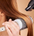 Hair, closeup and woman with hairdryer in studio for beauty, blowing and styling on brown background. Zoom, haircare and