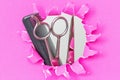 Hair comb and scissors on pink background, front view Royalty Free Stock Photo