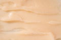 Hair conditioner cream background. Yellow cosmetic lotion moisturiser sample closeup. Body care balm, retinol serum