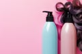 Hair curlers and shampoo bottles on pink background with copy space Royalty Free Stock Photo