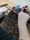 Hair on the Curling iron. Evening hairstyle. Royalty Free Stock Photo