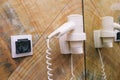 Hair dryer on the wall with socket and mirror. Electric hair dryer in the bathroom