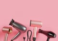 Hair dryers on pink background with copy space. Empty space for your text, advertising. Professional hair style tools