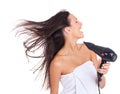 Hair-drying rock star. An attractive woman expressing enjoyment while drying her hair. Royalty Free Stock Photo